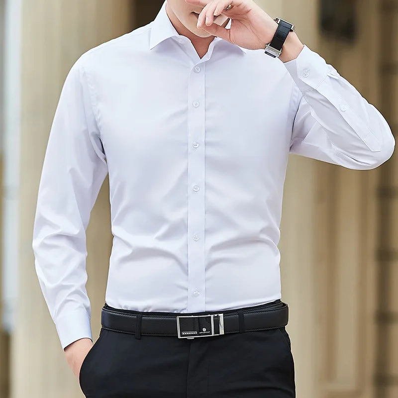 Man wearing a white dress shirt and black pants with a blurred background