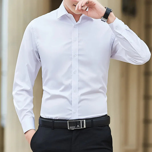 Man wearing a white dress shirt and black pants with a blurred background
